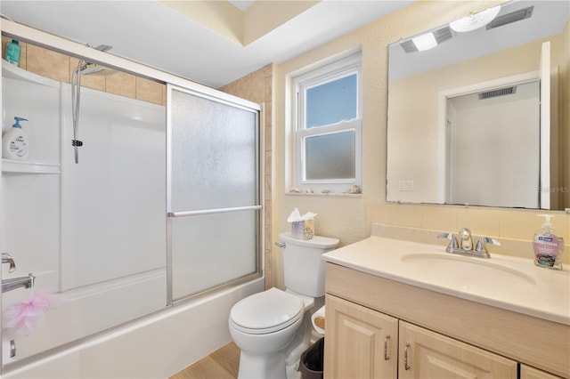 full bathroom featuring enclosed tub / shower combo, visible vents, toilet, and vanity