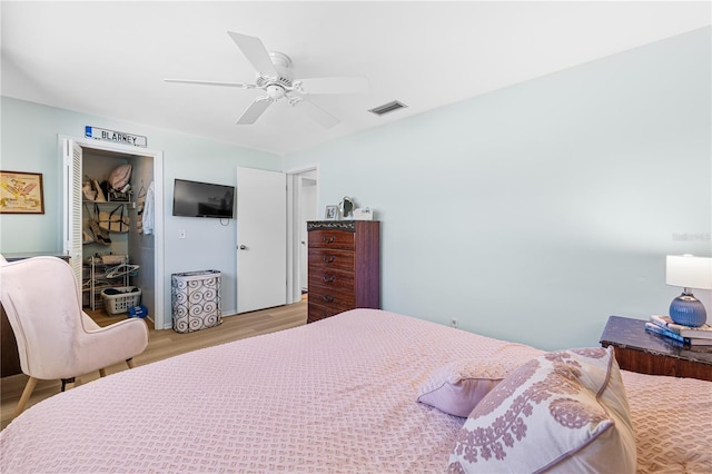 bedroom with light wood-type flooring, visible vents, and a ceiling fan