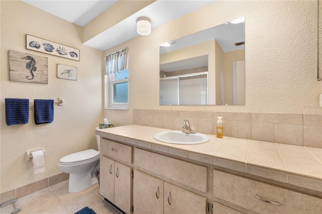 bathroom featuring vanity, visible vents, a shower stall, tile patterned floors, and toilet