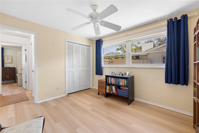 interior space with a closet, baseboards, and wood finished floors