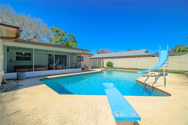 view of pool with a fenced in pool, a water slide, a fenced backyard, a sunroom, and a patio area