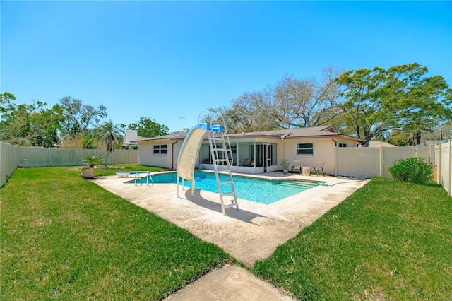 view of pool featuring a patio, a lawn, a fenced backyard, and a sunroom