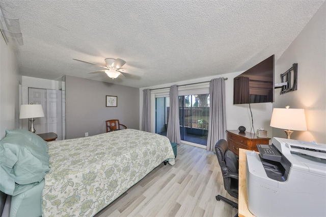 bedroom with access to exterior, a textured ceiling, a closet, light wood finished floors, and ceiling fan