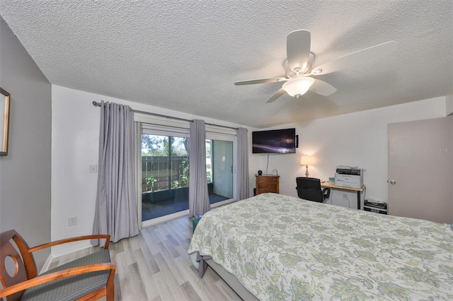 bedroom featuring light wood-style floors, access to exterior, a ceiling fan, and a textured ceiling