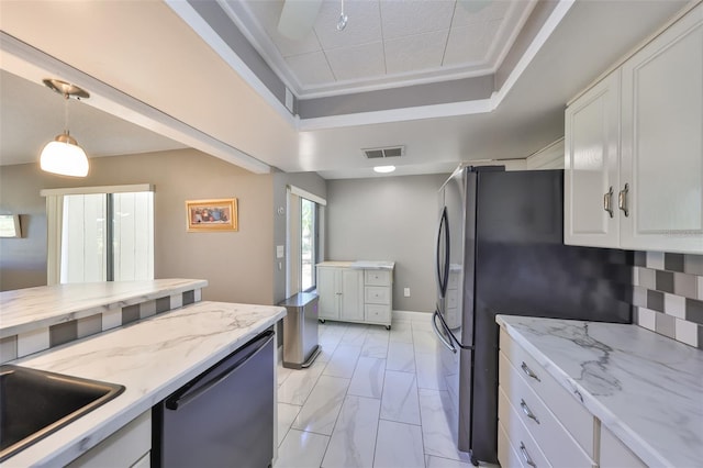 kitchen with visible vents, a tray ceiling, dishwashing machine, white cabinets, and marble finish floor