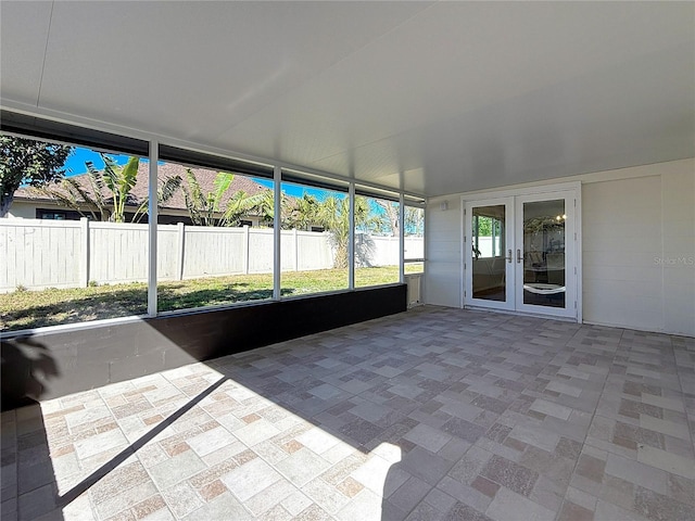 unfurnished sunroom with french doors