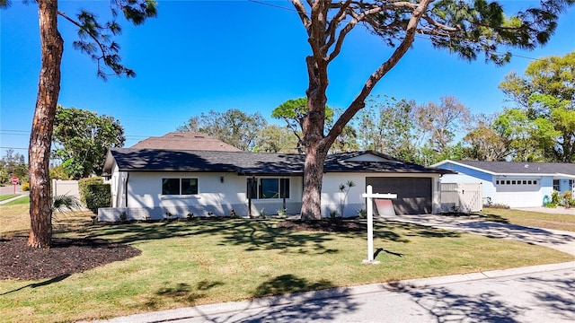 view of front of home featuring a garage, a front yard, driveway, and fence