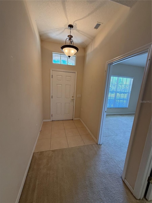 entrance foyer with visible vents, plenty of natural light, and a textured ceiling