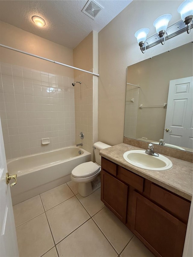 full bath with visible vents, tub / shower combination, toilet, tile patterned floors, and a textured ceiling