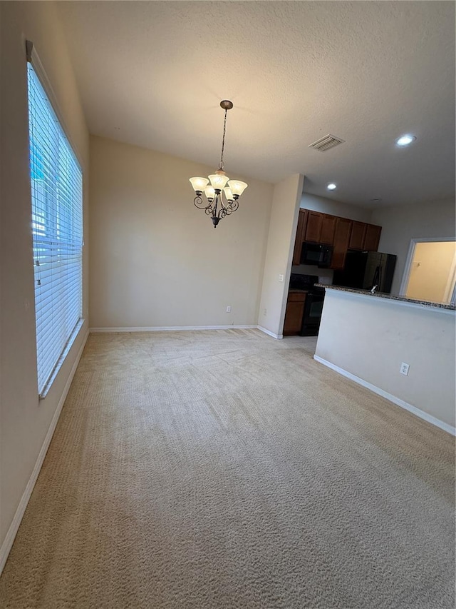 interior space featuring visible vents, baseboards, light carpet, a notable chandelier, and a textured ceiling