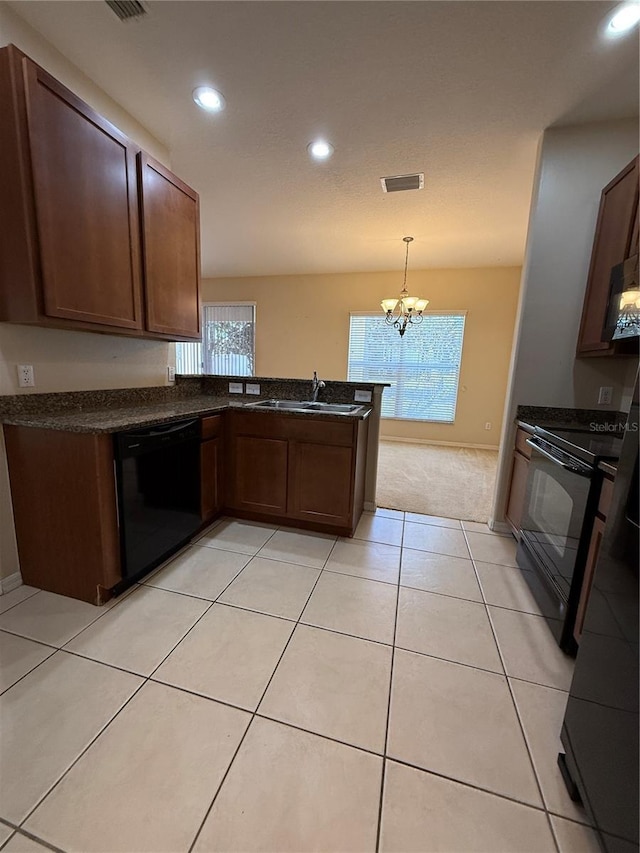 kitchen featuring visible vents, a chandelier, light tile patterned floors, black appliances, and a sink