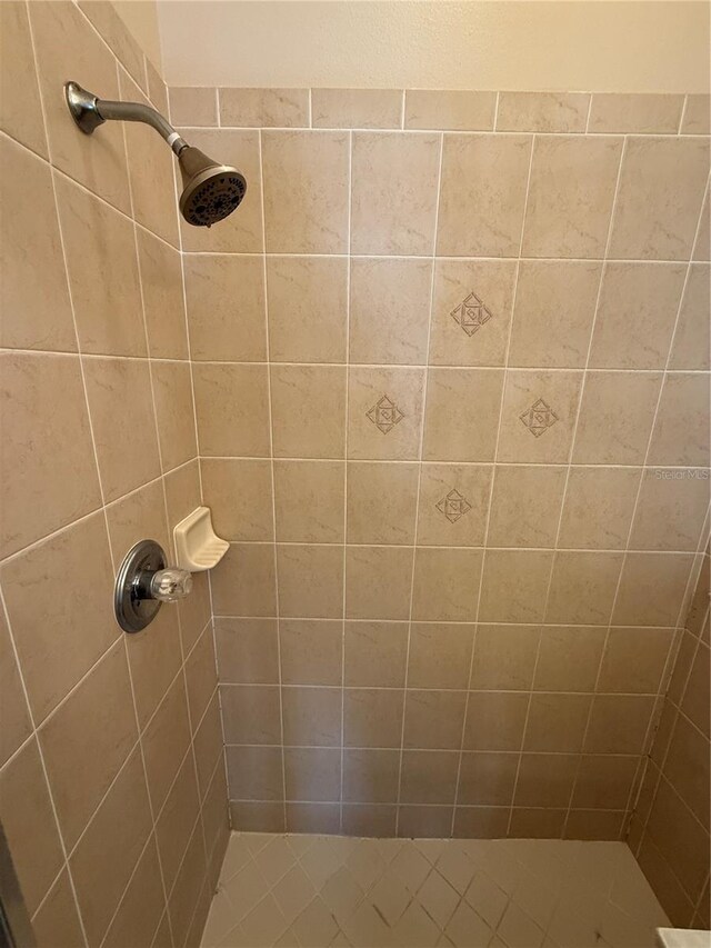 full bathroom with a tile shower