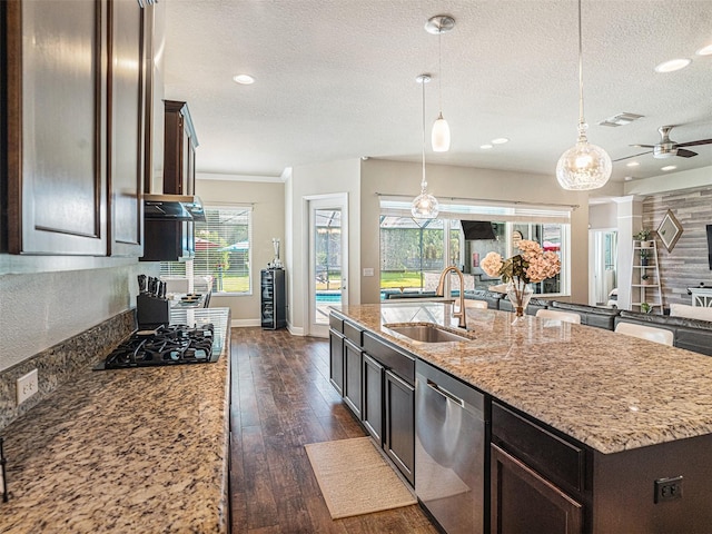 kitchen with dark wood-style floors, a sink, a textured ceiling, dishwasher, and black gas stovetop