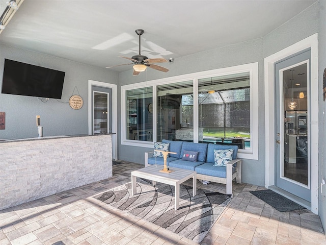 view of patio featuring an outdoor living space and ceiling fan