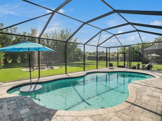 outdoor pool featuring a yard, glass enclosure, and a patio