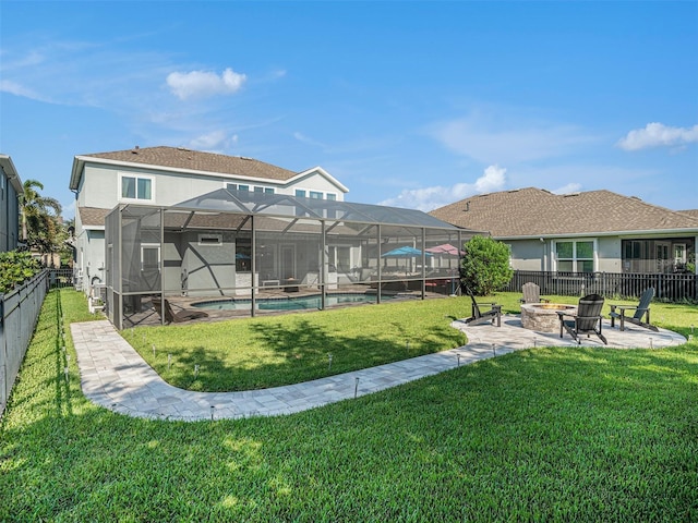 view of yard with glass enclosure, an outdoor pool, a fire pit, and a fenced backyard