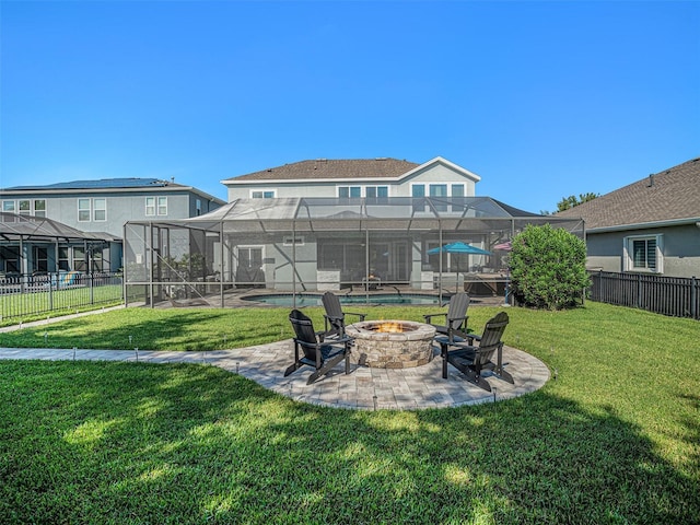 view of yard with fence, glass enclosure, a fire pit, an outdoor pool, and a patio area