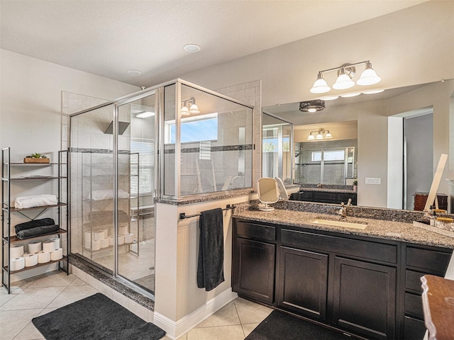 full bath with vanity, tile patterned floors, and a stall shower