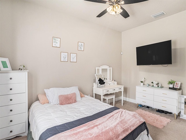 bedroom featuring visible vents, baseboards, light colored carpet, and a ceiling fan