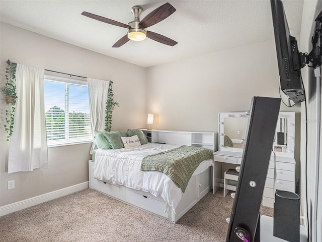 bedroom featuring carpet flooring, a ceiling fan, baseboards, and a textured ceiling