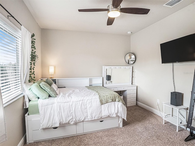 bedroom featuring visible vents, carpet, baseboards, and ceiling fan