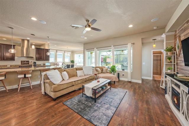 6617 Park Strand Dr, Apollo Beach, FL 33572 - living room featuring a textured ceiling, dark wood-style flooring, baseboards, a ceiling fan, and recessed lighting
