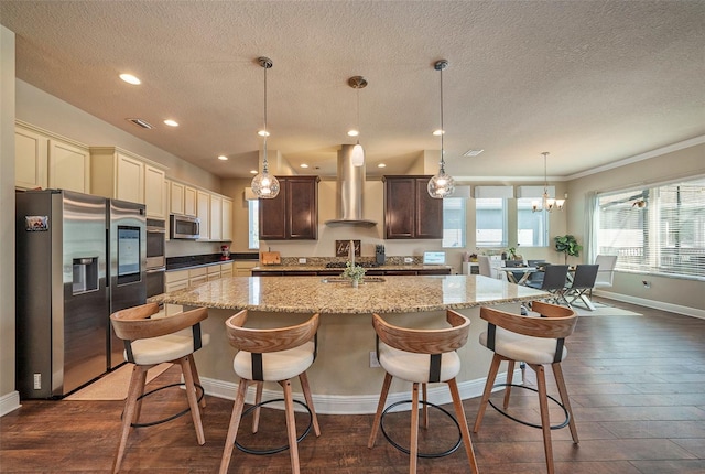 6617 Park Strand Dr, Apollo Beach, FL 33572 - kitchen featuring stainless steel appliances, wall chimney range hood, a textured ceiling, recessed lighting, and dark brown cabinetry