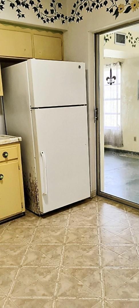 kitchen with visible vents and freestanding refrigerator