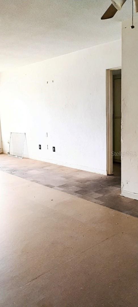 unfurnished room featuring a textured ceiling and concrete floors