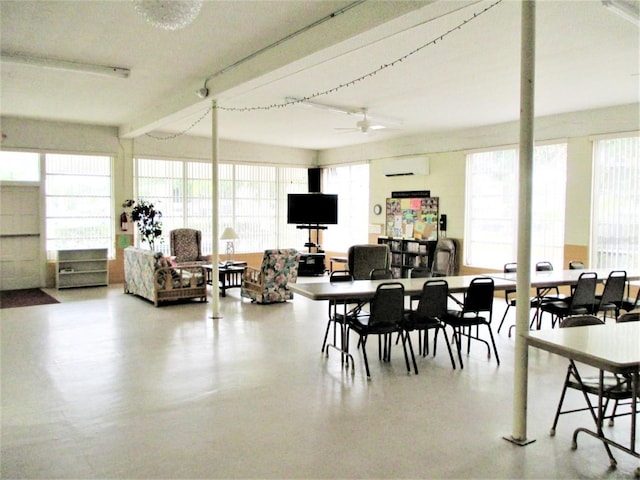 dining area with a ceiling fan and a wall unit AC