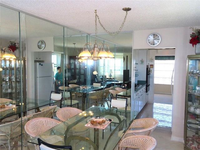 dining room with plenty of natural light, a chandelier, and a textured ceiling