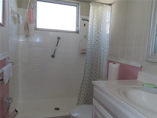 full bath with vanity, a shower stall, and toilet