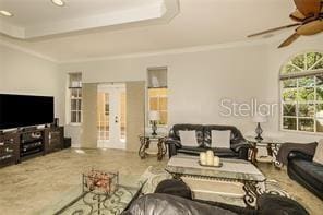 living room with ceiling fan and ornamental molding