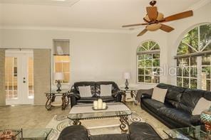 living room featuring crown molding and a ceiling fan