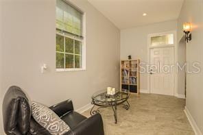 living area featuring baseboards