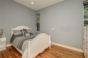 bedroom featuring recessed lighting, baseboards, and wood finished floors