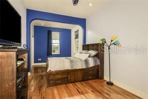 bedroom featuring wood finished floors