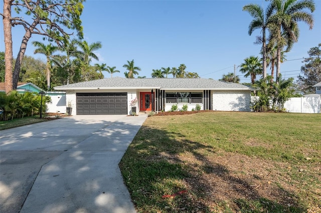 single story home with driveway, a front lawn, a garage, and fence