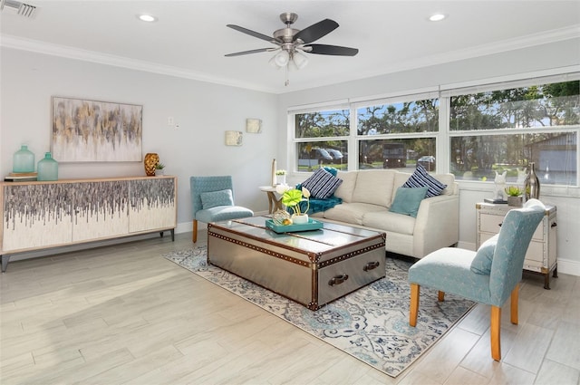 living room with visible vents, crown molding, baseboards, and wood finished floors