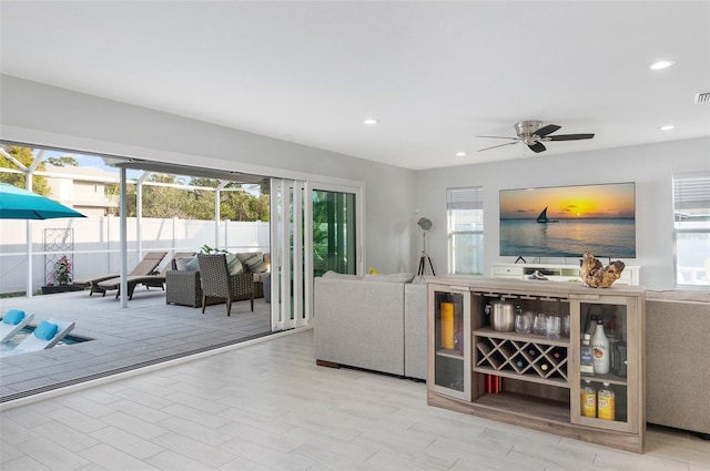 living room featuring a ceiling fan, beverage cooler, recessed lighting, and visible vents