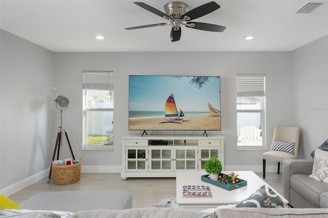 living area with recessed lighting, a healthy amount of sunlight, and visible vents