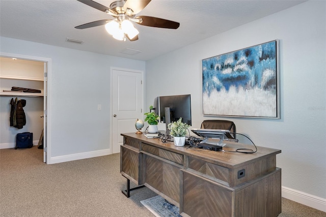 office space with visible vents, a ceiling fan, baseboards, and carpet floors