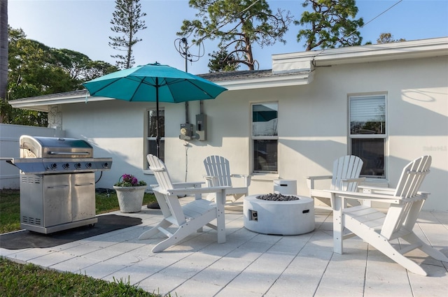 view of patio / terrace featuring grilling area and a fire pit