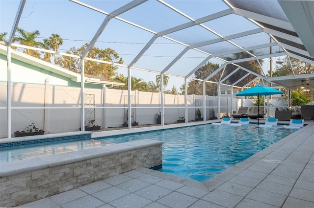 view of swimming pool with a fenced in pool, a fenced backyard, a lanai, a patio area, and an outdoor hangout area