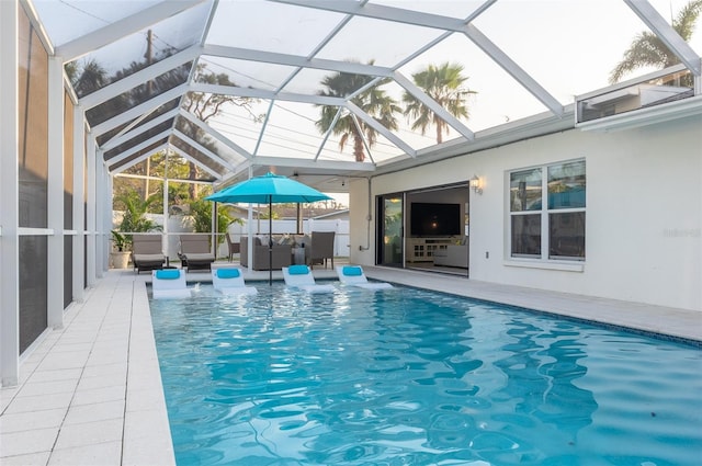 view of swimming pool featuring a patio area, a fenced in pool, and a lanai