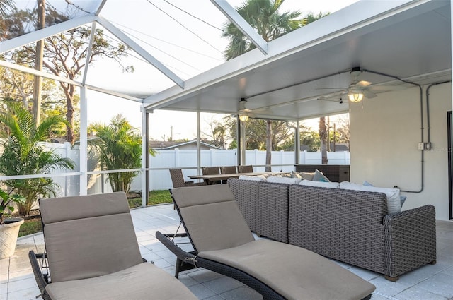 view of patio with ceiling fan, a fenced backyard, a lanai, and outdoor lounge area