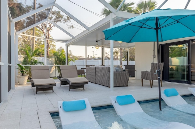 view of patio featuring glass enclosure, a ceiling fan, a fenced in pool, and outdoor lounge area