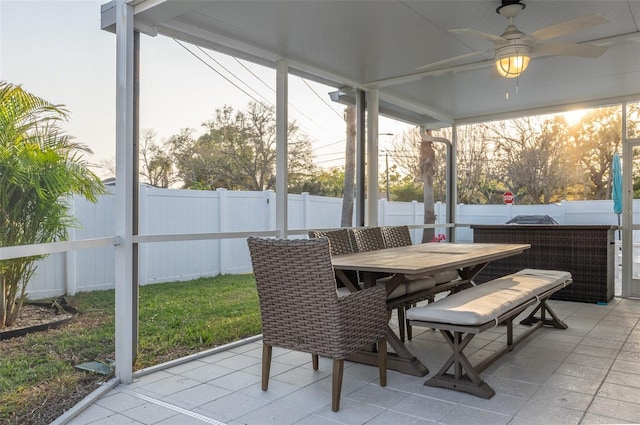 sunroom / solarium featuring ceiling fan