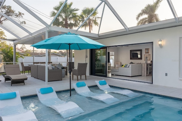 view of pool featuring a patio, fence, glass enclosure, outdoor lounge area, and a fenced in pool