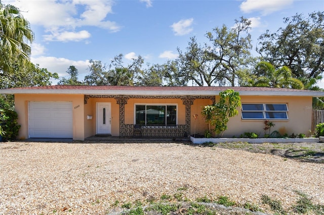 single story home with stucco siding, driveway, and a garage